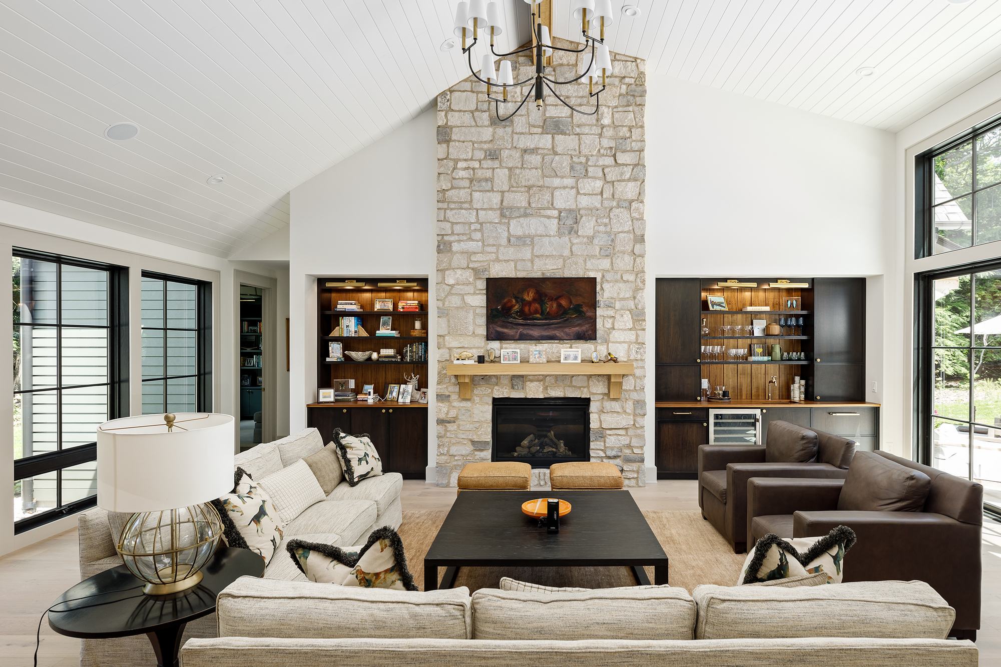 Great room with stone fireplace and walnut built-ins